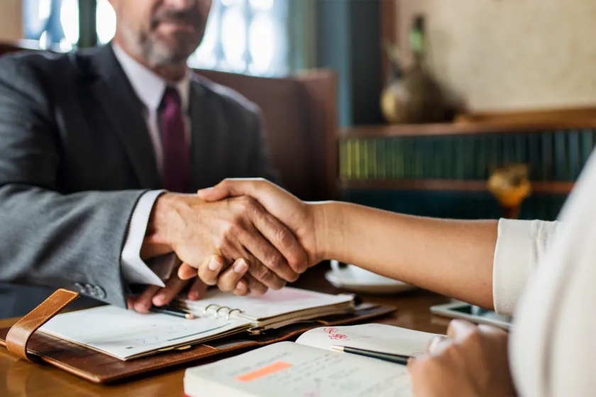 A handshake across a desk after a consultation